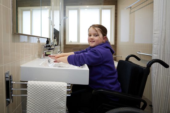 Hayley in her new accessible bathroom designed by Home Modification Victoria.