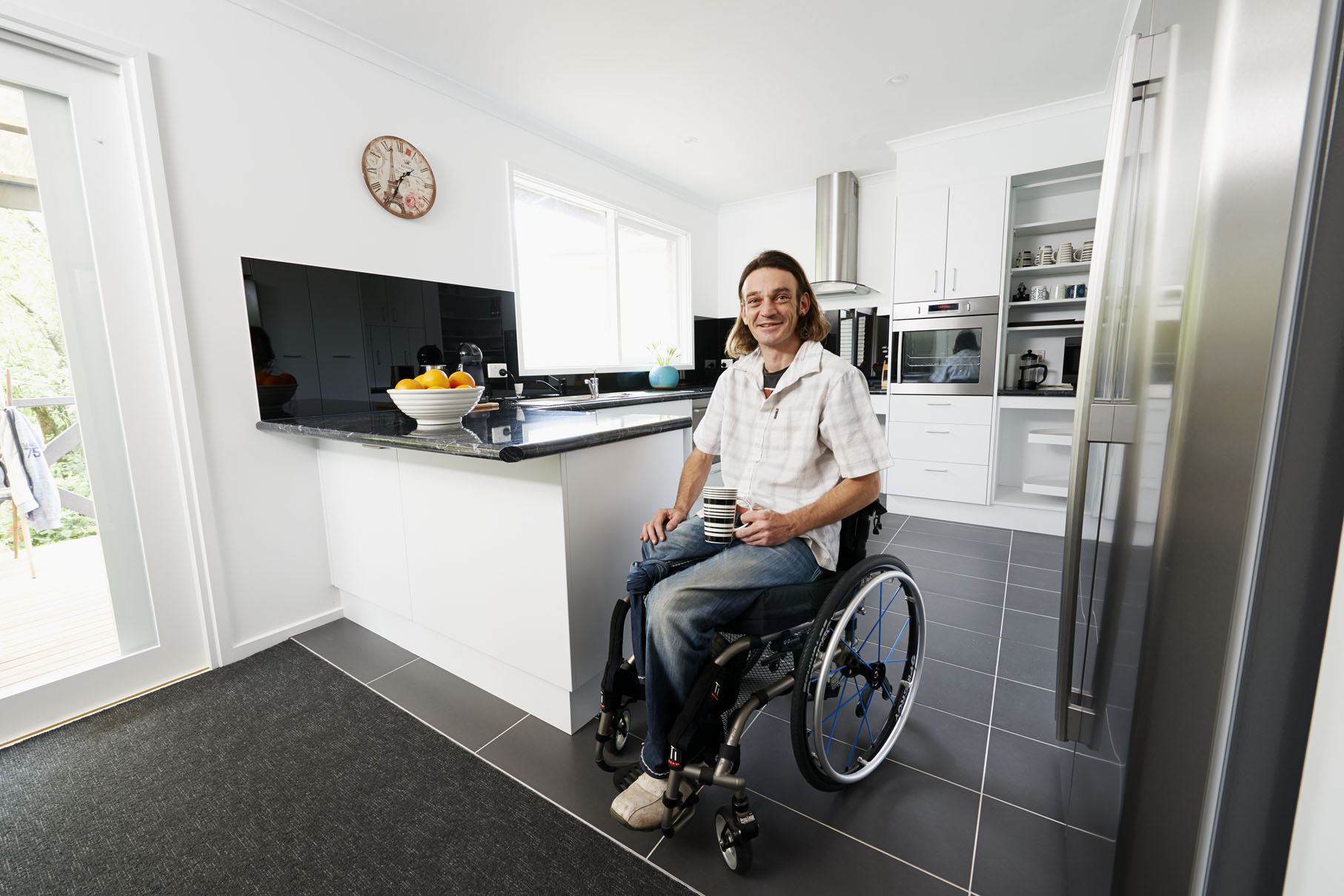 Man in wheelchair in accessible kitchen
